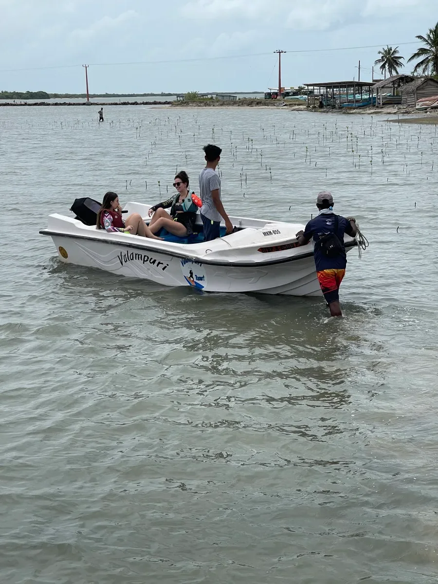 Boat loaded with kite gear heading out on a Kalpitiya kite trip