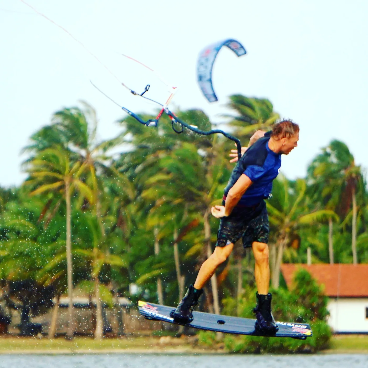 Kitesurfer jumping in front of the palms at Kalpitiya