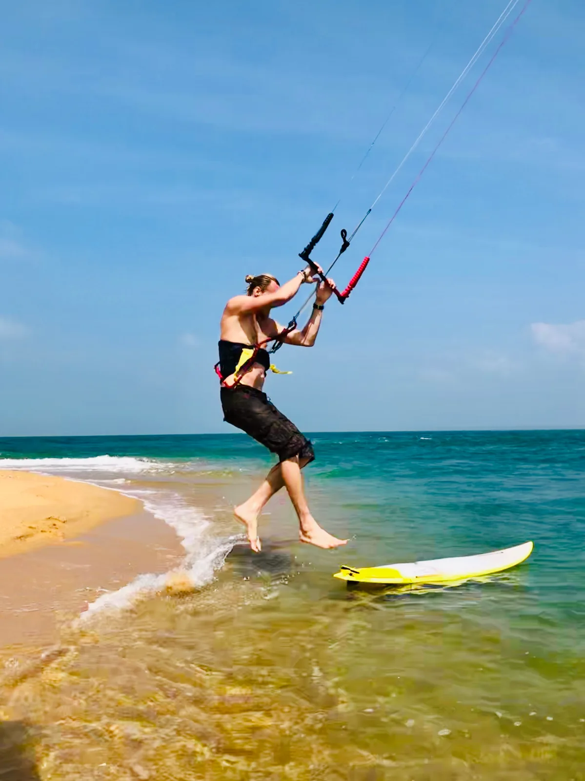 Kitesurfer jumping onto a sandbar near Kalpitiya