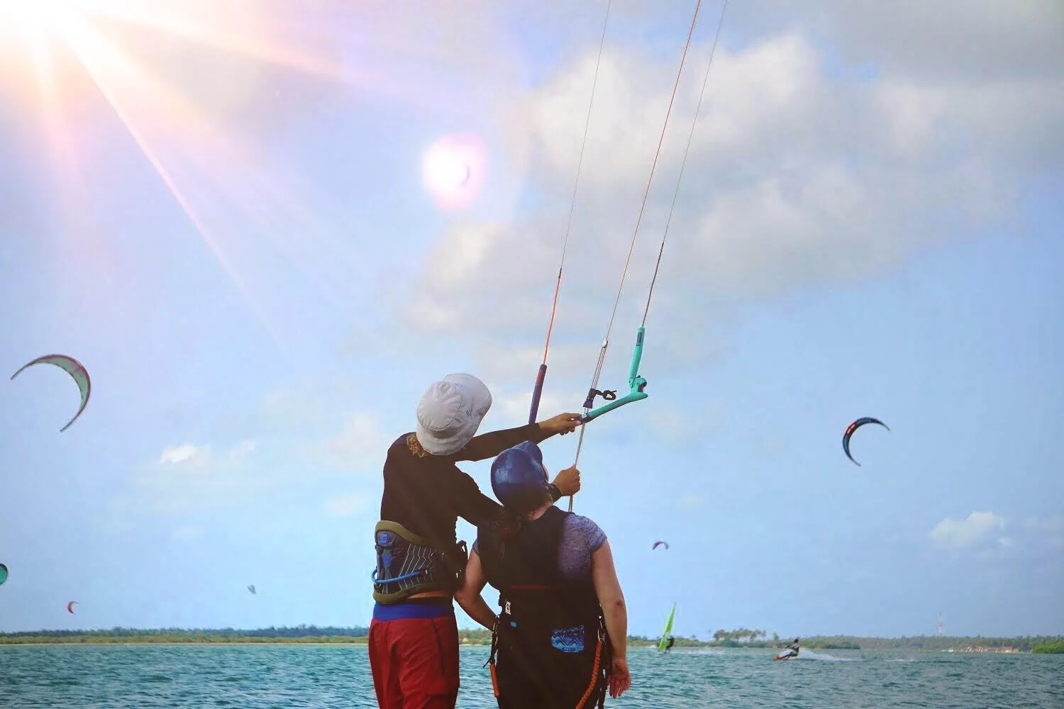 Kitesurfing lesson under a sky full of kites on Kalpitiya Lagoon, Sri Lanka